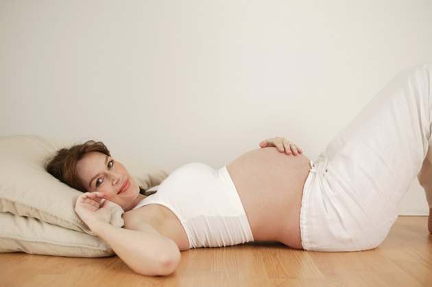 Pregnant woman lying on floor