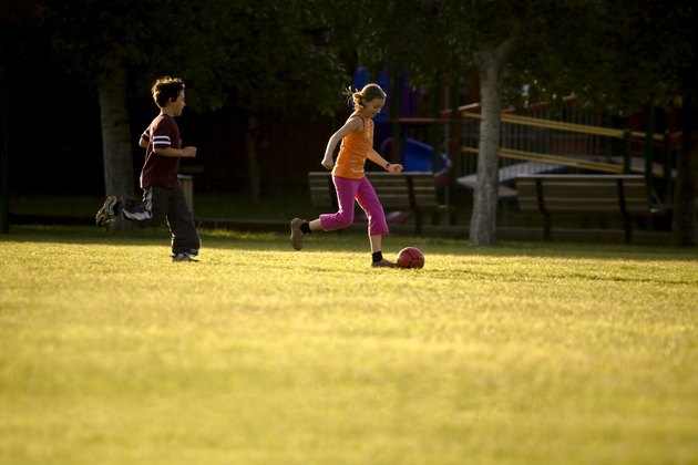 Two kids playing soccer