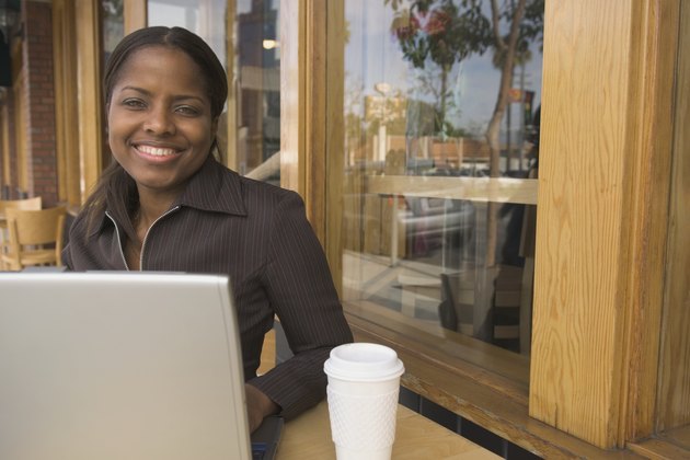 African businesswoman with laptop at cafe