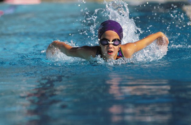 A young girl swimming in a pool