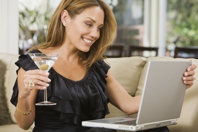 Hispanic woman looking at laptop