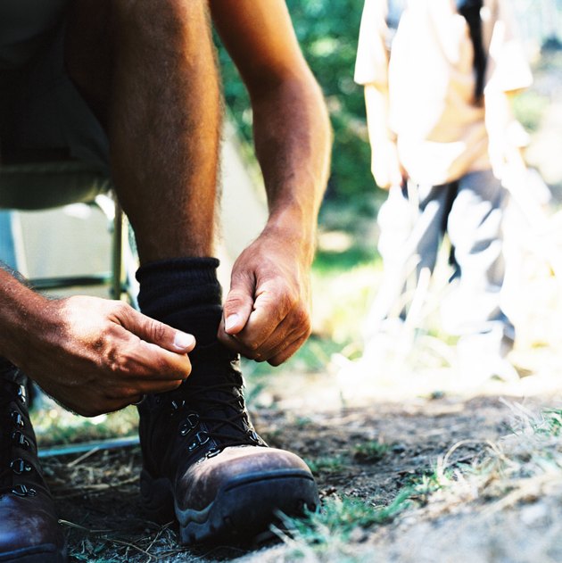 man tying the laces of his boots