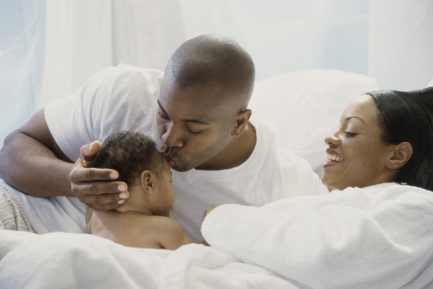 Parents and their son on the bed