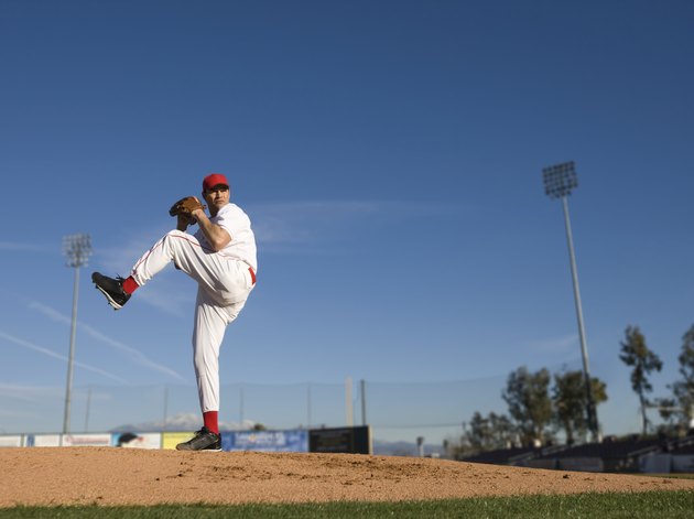 USA, California, San Bernardino, baseball pitcher throwing pitch, outdoors