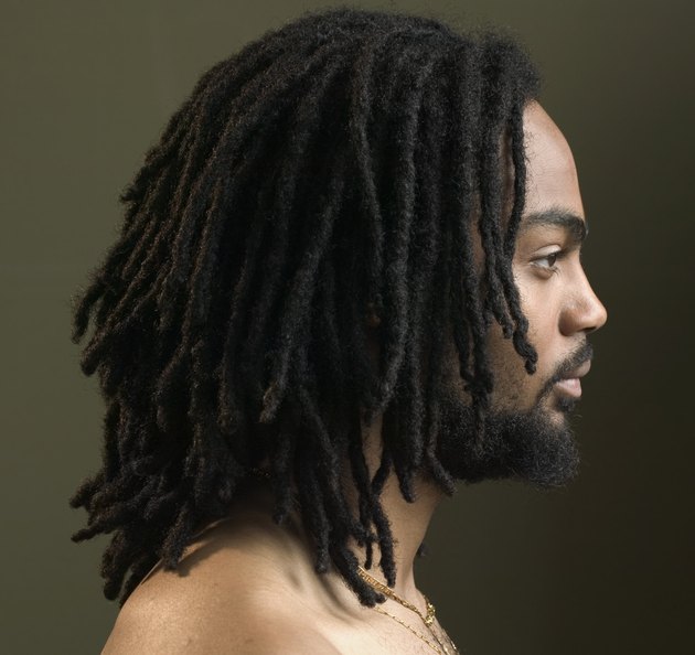 Side profile of a young man with dreadlocks