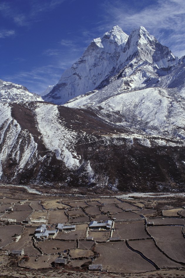 Mountainous landscape with valley and village in forefront