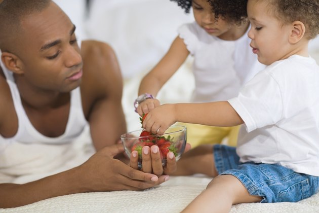African father and children eating fruit