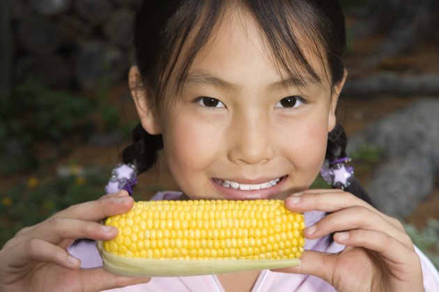 Girl holding ear of corn