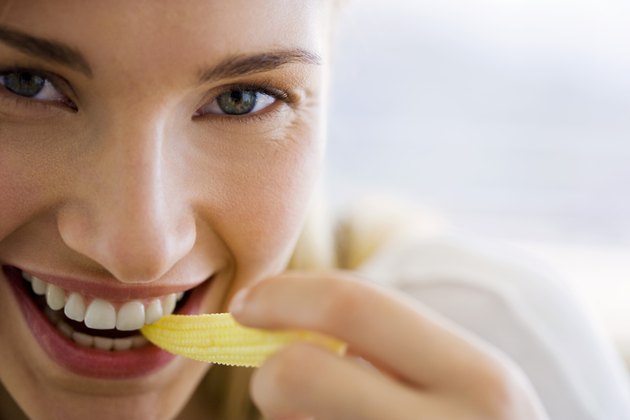 Woman eating corn
