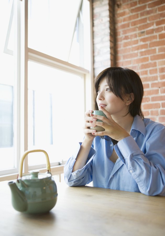 Young woman drinking a cup of tea