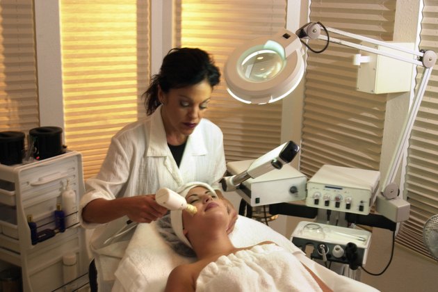 Woman getting facial from dermatologist