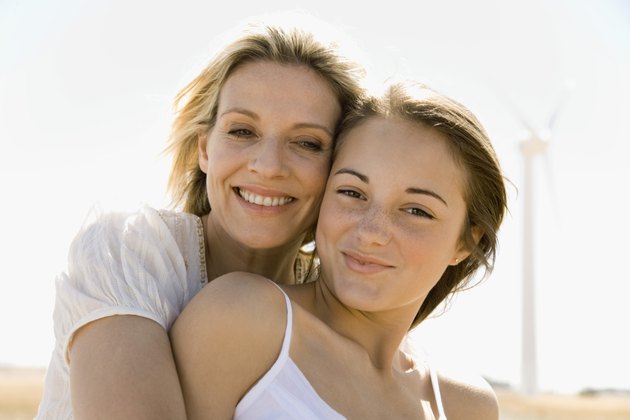 Portrait of mother hugging daughter