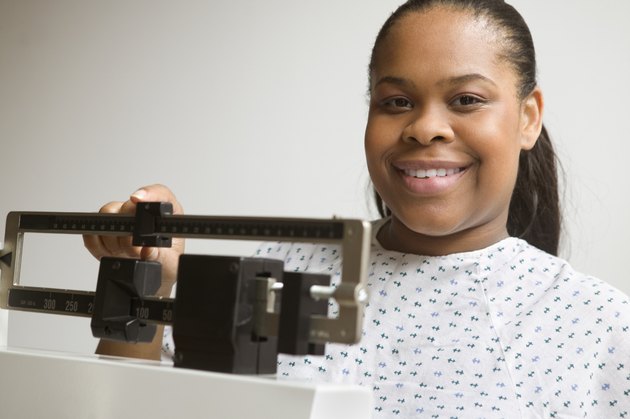 African American woman weighing herself