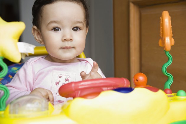 Hispanic baby girl playing with toy