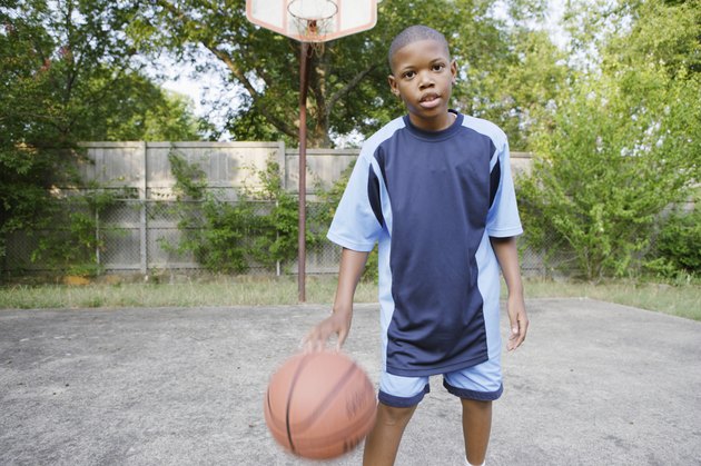 Young boy dribbling basketball