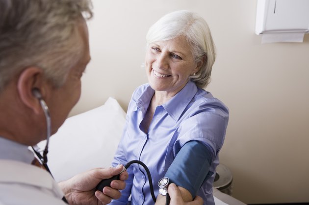 Doctor taking patient's blood pressure