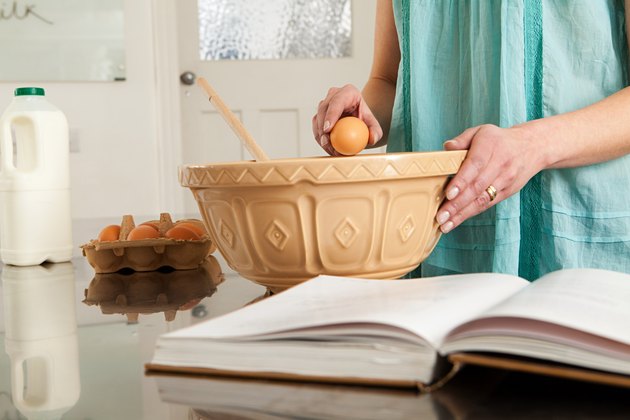 Woman breaking egg into bowl