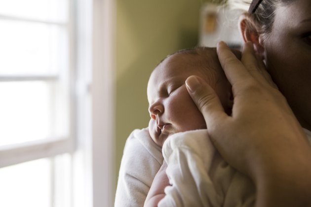 Close-up of a young woman holding her baby