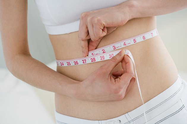 Woman measuring waist