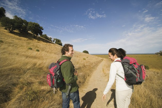 Rear view of couple laughing and hiking