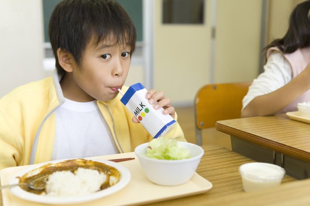 Boy drinking milk at desk