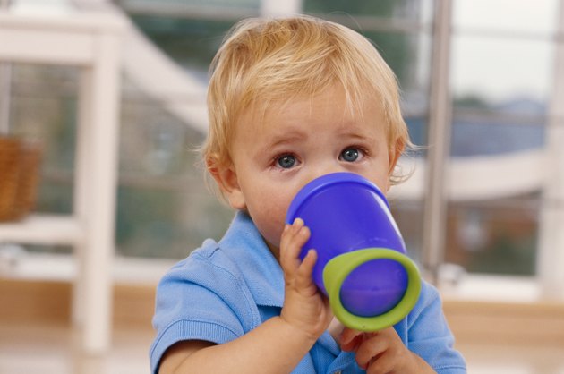 Baby boy (12-15 months) drinking from mug, close-up