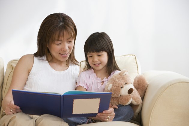 Asian mother and daughter reading
