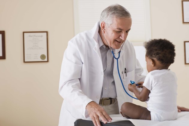 Toddler playing with doctors stethoscope