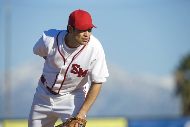 USA, California, San Bernardino, baseball pitcher preparing to throw, outdoors