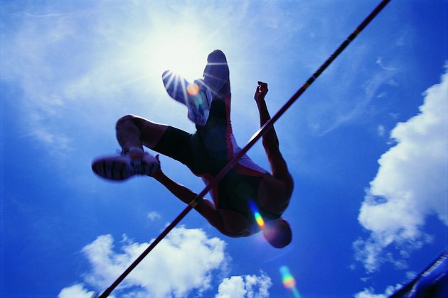 Athlete going over bar in high jump