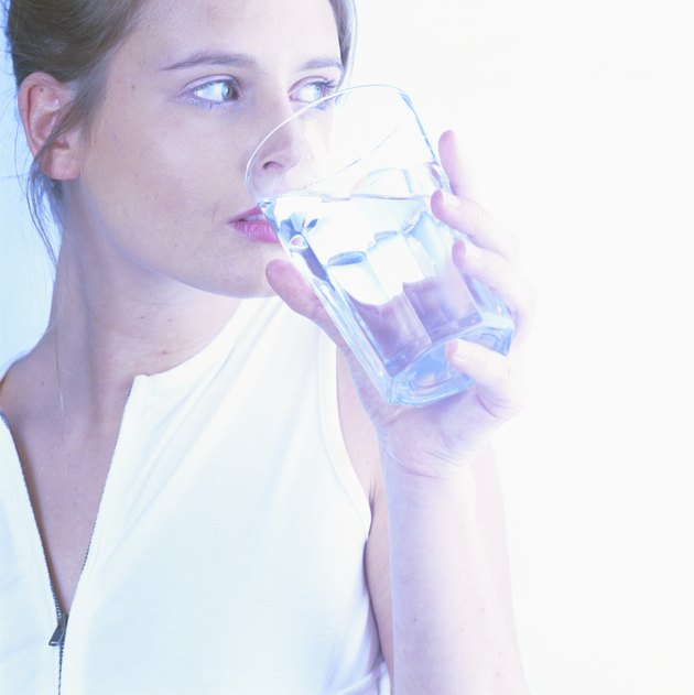 Woman holding glass of water (cross-processed)