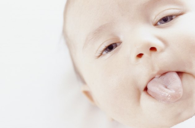 Baby (3-6 months) sticking out tongue, close-up