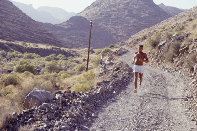 Man jogging down mountain track