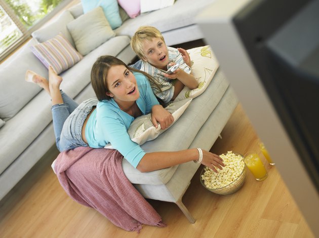 Brother (7-9) and sister (14-16) watching television