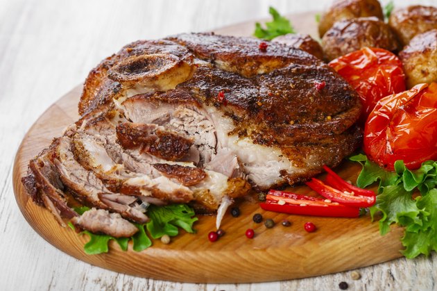 roasted pork shoulder on the bone with potatoes