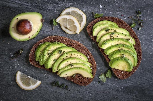 Avocado sandwich on dark rye bread made with fresh sliced avocados.