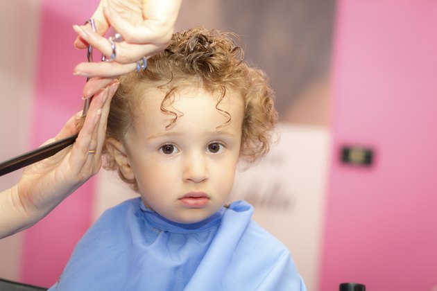 Hairdresser and toddler with curly hair
