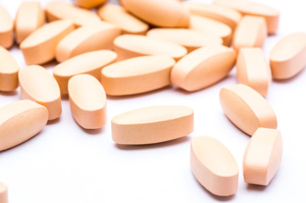vitamin orange pills on a white background