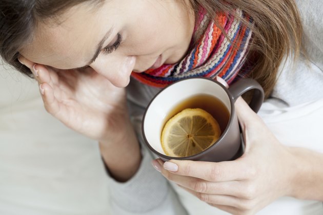Ill woman drinking tea