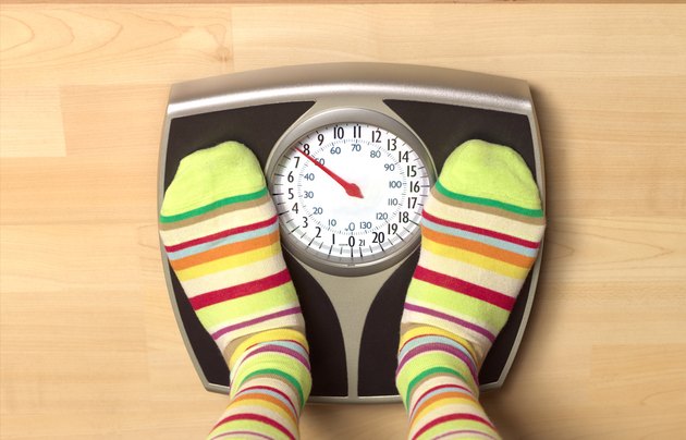 Dieting woman on bathroom scales