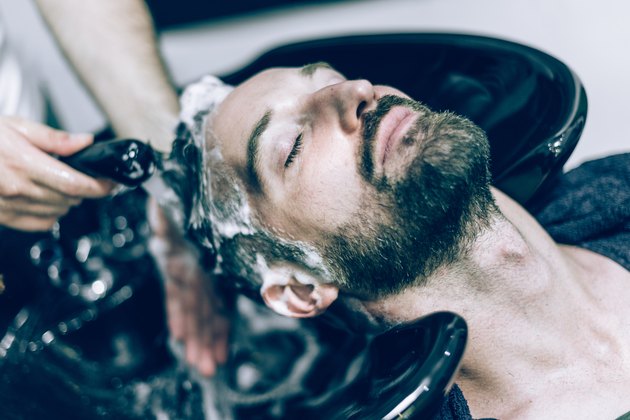 relaxed bearded man receives hair shower