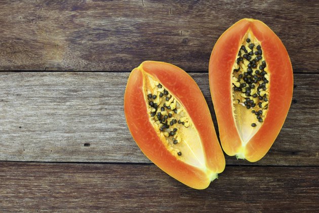 Sliced fresh papaya on wooden background