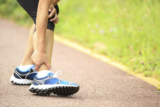 woman runner hold twisted ankle