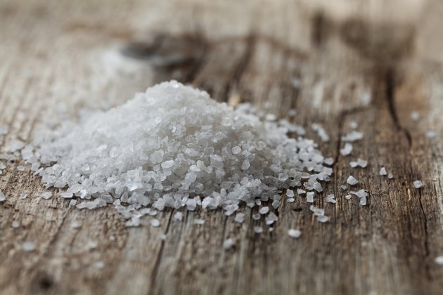 Sea salt on rustic wooden background
