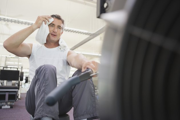 Fit man working out on rowing machine