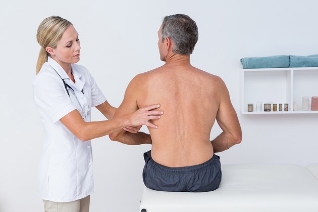 Doctor examining her patient arm