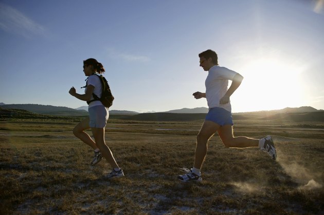 Man and woman running at sunset, California, USA