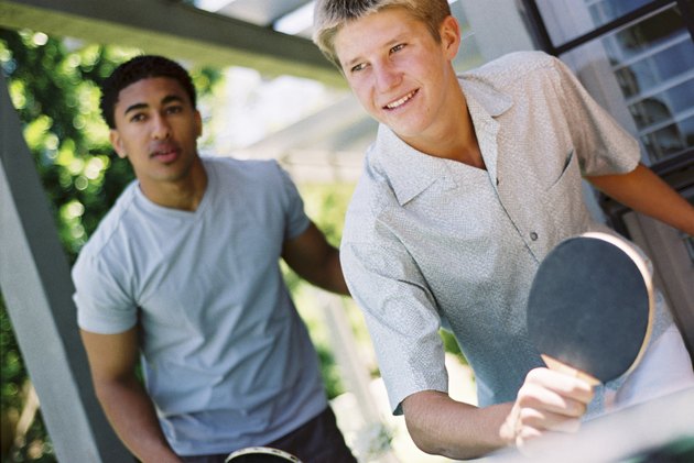 Teens playing table tennis