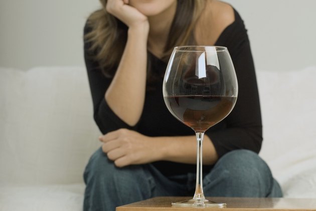 Portrait of a young woman sitting with her hand on her chin