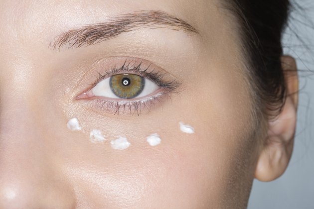 Dots of moisturiser on womans face